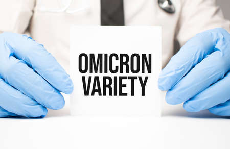Doctor holding a card with text OMICRON VARIETY, medical conceptの写真素材