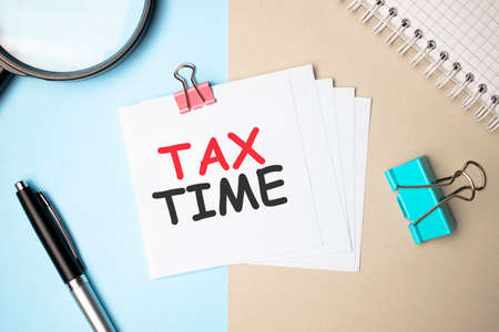 On a light background, dollars, glasses, a magnifying glass, pen and a notebook with the inscription...