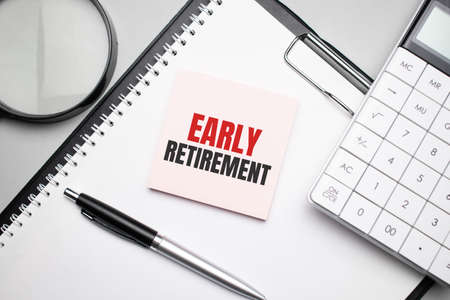 EARLY RETIREMENT. Notepad, eyeglasses and white pen. Financial conceptの写真素材