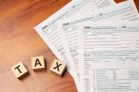 Word TAX written on wooden cubes. Tax concept