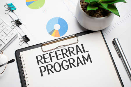 Paper with Referral Program on the table, calculator and moneyの写真素材