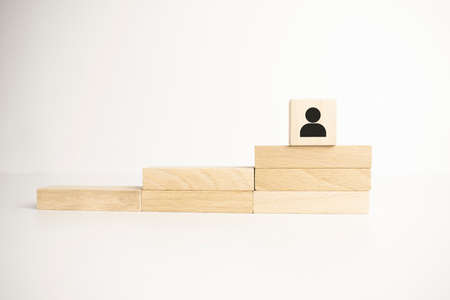 Career Growth Concept. Wooden model on red super mens coat climbing by ladder.