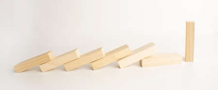 top view of falling wooden blocks isolated on grey, domino effect conceptの写真素材