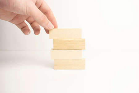 Hand arranging wood block stacking as step stair. Business concept for growth success processの写真素材