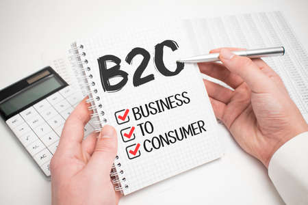 Businessman Writing B2C Concepts on his Noteの写真素材