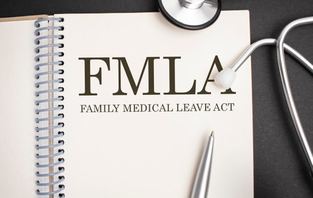 Page with FMLA Family Medical Leave Act on the table with stethoscope, medical concept