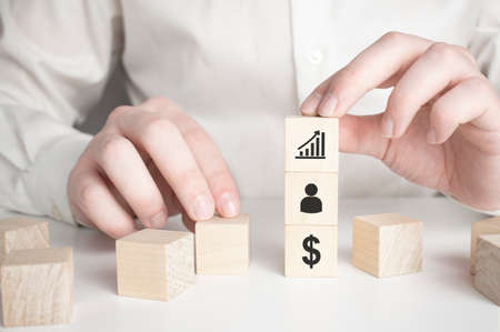 hand holding wooden cube with arrow pointing to dollar symbol icon Ideas for the success of business growthの写真素材