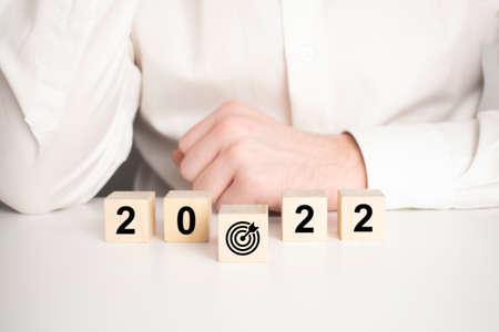 Businessman pushing target board in front 2022 year for start new year business plan.の写真素材