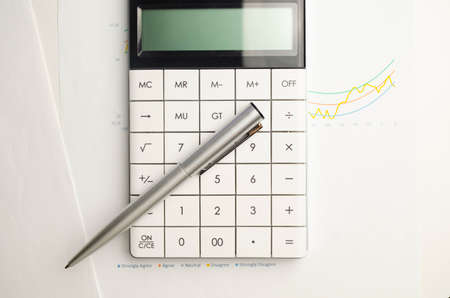 Calculator with pen on financial data. Concept of Business and Finance research.の写真素材