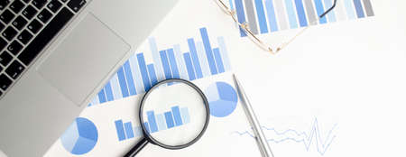 office desktop. Calculator, Glasses, Magnifier, Notepad, Pen, Coffee Cup. On a white background. top view. Free space for text. high quality photoの写真素材