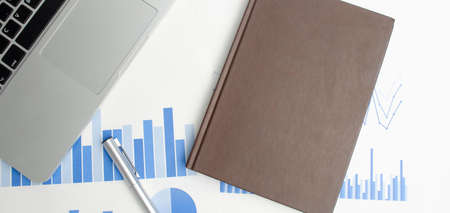 business background. financial report and laptop, on business desk. high quality photo