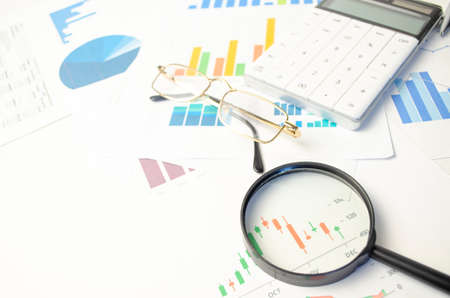 Calculator on chart and graph spreadsheet paper. Finance development, Banking Account