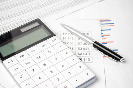 Calculator with pen on stock market analysis. Concept of Business, Finance and Audit research.の写真素材