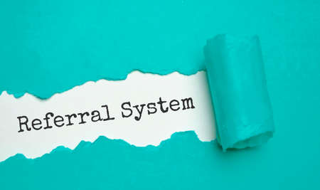 Referral System word written under torn paper, businessの写真素材