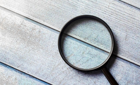 Directly Above Shot Of Magnifying Glass On Tableの写真素材