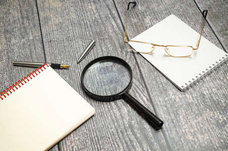 Magnifying glass on Calculator with documents on table. tax conceptの写真素材