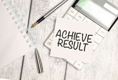 Achieve result Written words on paper notebook . workplace. business concept.の写真素材