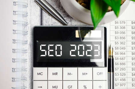 calculator with text seo 2023 on display and penの写真素材