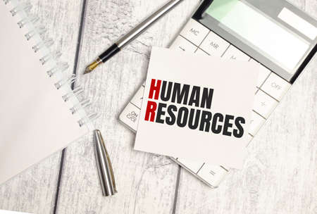 human resources text on sticker with calculator, glasses and magnifierの写真素材