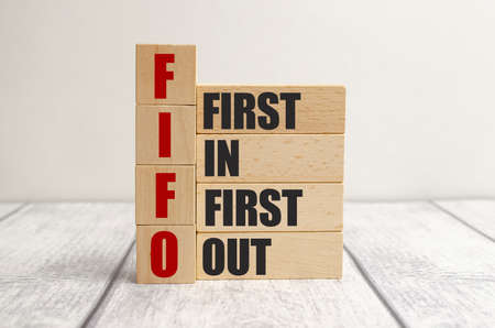 FIFO First in, first out word on wooden cubes on wooden background
