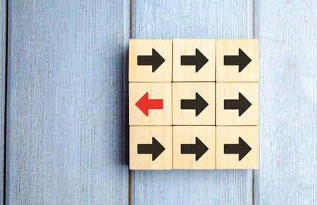 Wooden Block With Red Arrow Facing The Opposite Direction Black Arrow