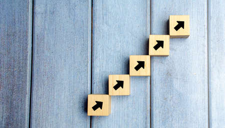 wooden blocks stacking as step stair with arrow up, Business growth success process concept, copy spaceの写真素材