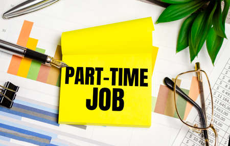 paper part time job text on yellow sticker and chartsの写真素材