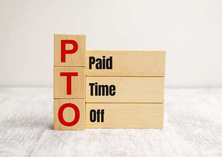 On the wooden blocks with the inscription - paid time offの写真素材