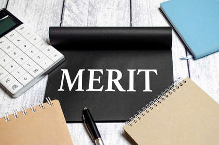 Notepad with text merit with calculator and notepadsの写真素材