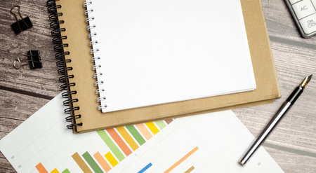 Office workplace table with report page, supplies and pen