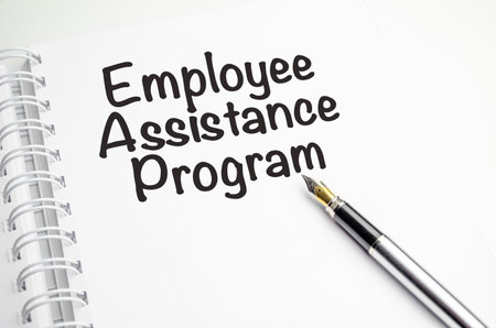 EAP Employee Assistance Program - word on a white notebook against the backgroundの写真素材