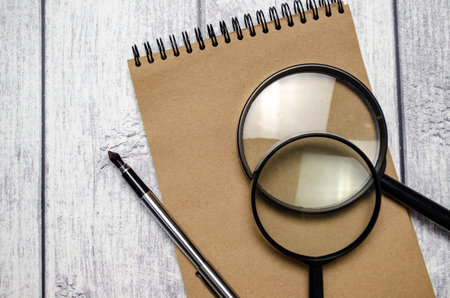 Office supplies with documents close up and wooden backgroundの写真素材