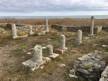 Column remnants at the Ancient Roman settlement at Histria, in Dobrogea Romania, with the Black Sea in the far background on the horizon lineの写真素材