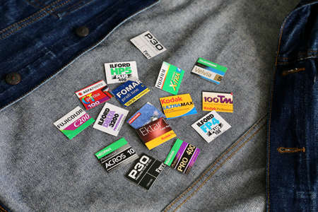 Bucharest Romania, October 18 2020: 35 mm film box carton cutouts from various film stocks placed on denim jacket undersideのeditorial素材