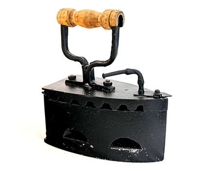 An old coal black  iron  clothes separate on white with wood handdelの写真素材