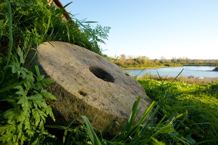 Vintage millstones at shore of Teletskoye Lakeの写真素材