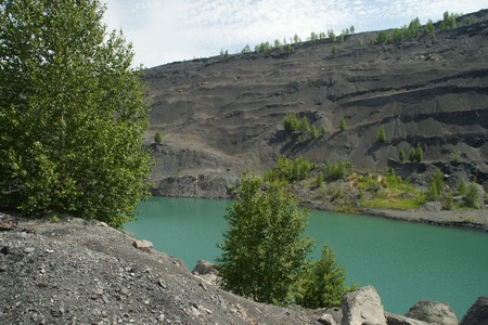 Abandoned and flooded quarry for coal mining in the Kemerovo region