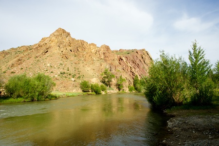 Beautiful sunny valley between the mountains with lush clouds in the Altai Republicの写真素材