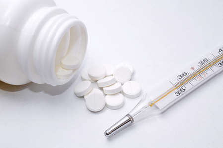 medical thermometer of a tablet  from the container