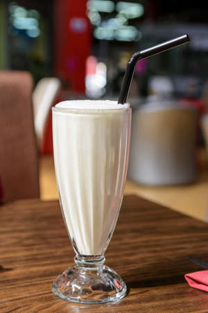 milk cocktail with a straw in a glassの写真素材