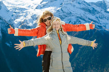 mother with daughter on a background of mountainsの写真素材