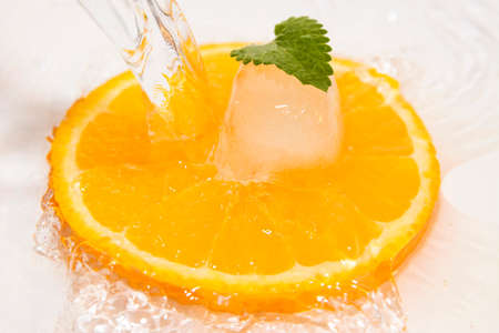juicy oranges slice with ice and mintの写真素材