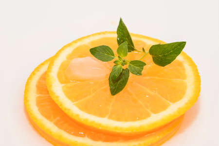 juicy oranges slice with ice and mintの写真素材