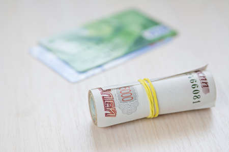 a credit card and the Russian rubles on a white backgroundの写真素材