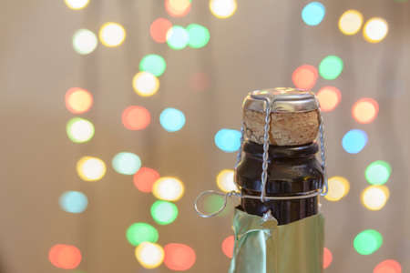 closed bottle of champagne on the background of lightsの写真素材