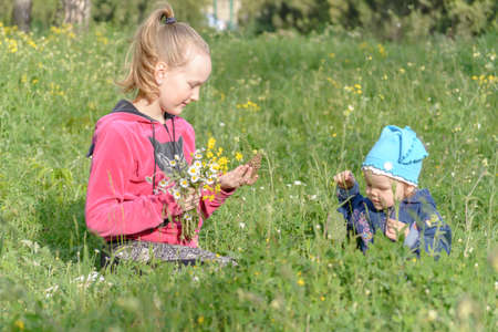 girls with a bouquet of wildflowers in a meadowの写真素材