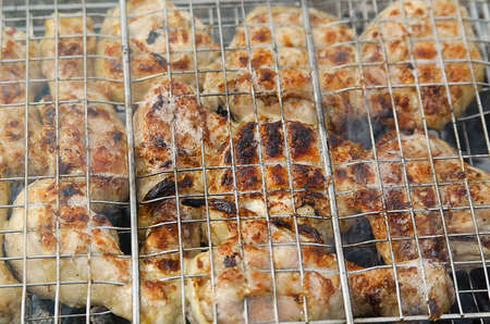 chicken cooking on a fire in the grate barbecue