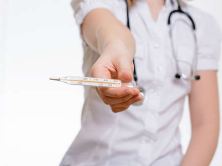 Doctor gives a thermometerの写真素材