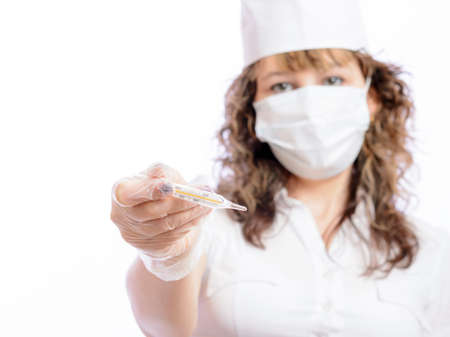 doctor in medical mask gives thermometerの写真素材