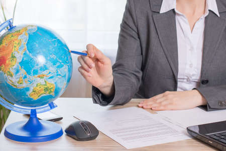 Manager indicates location on the globeの写真素材